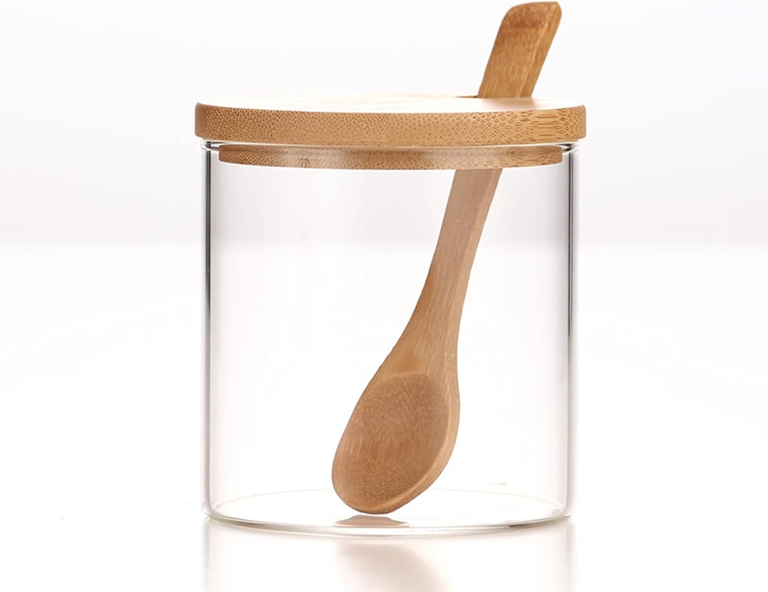 One clear glass jar with a bamboo lid and wooden spoon