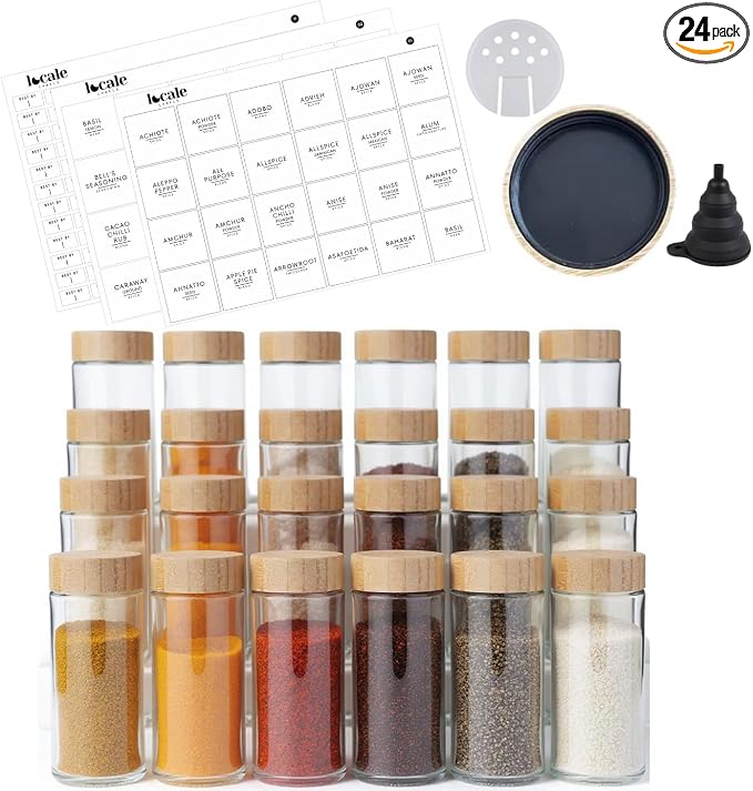 Twenty-four small glass spice jars with bamboo lids, labels, and funnel
