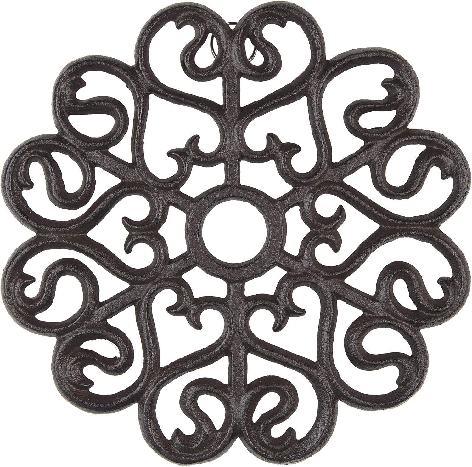 Brown cast-iron trivet with a scrollwork design