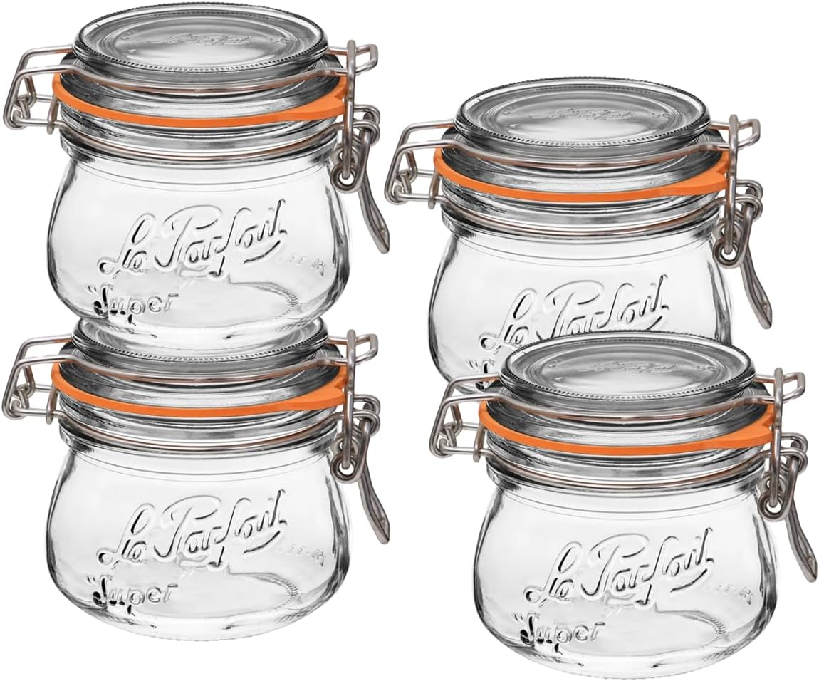 Four clear glass Le Parfait jars with wire-bail closures